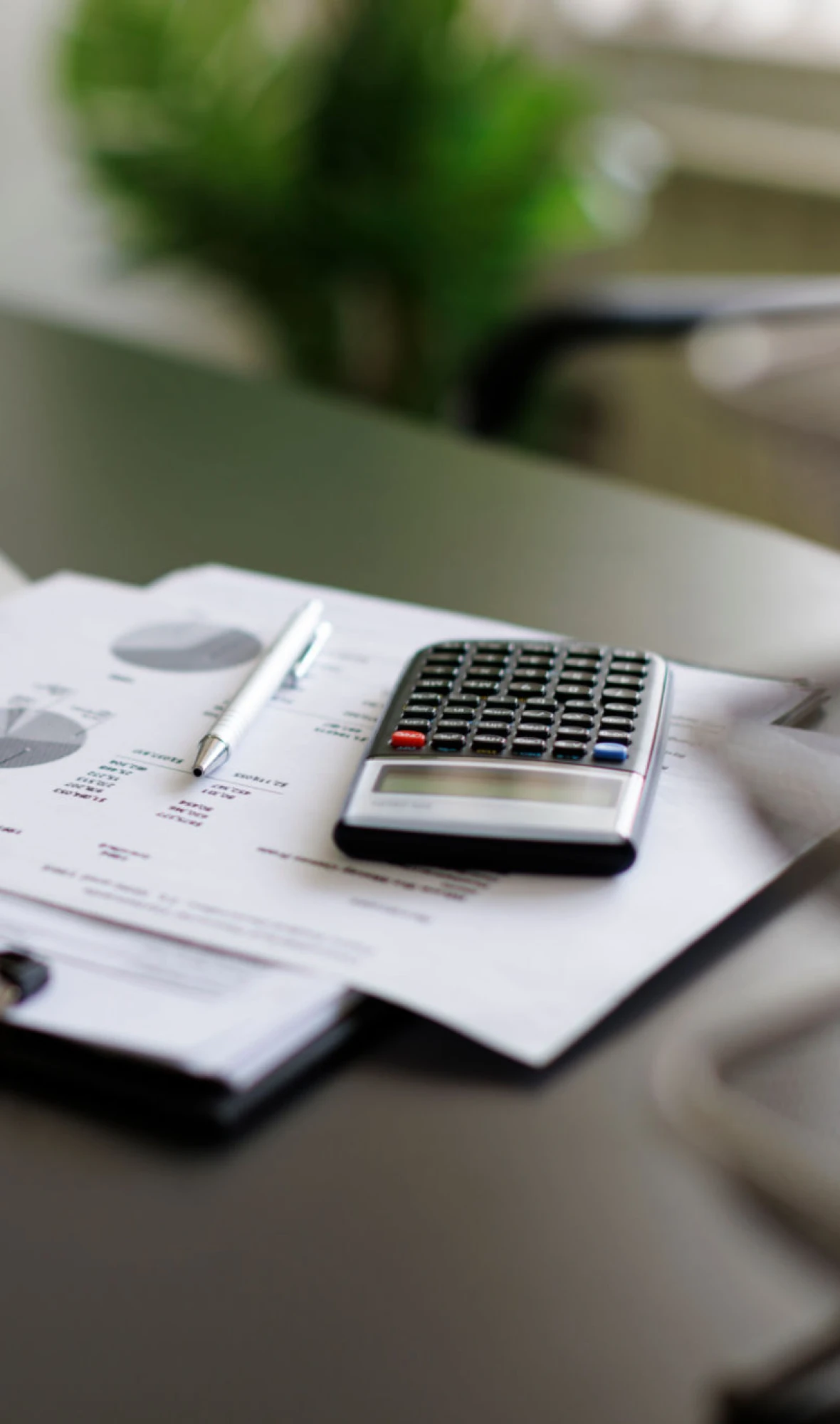 Office desk with calculator and papers